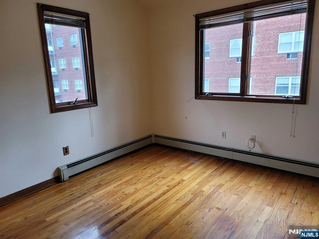 16 Jefferson Street Hackensack, NJ 07601 - Photo 24 of 29 a view of an empty room with wooden floor and a window