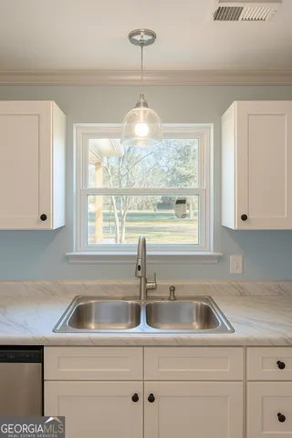 a kitchen with a sink cabinets and window