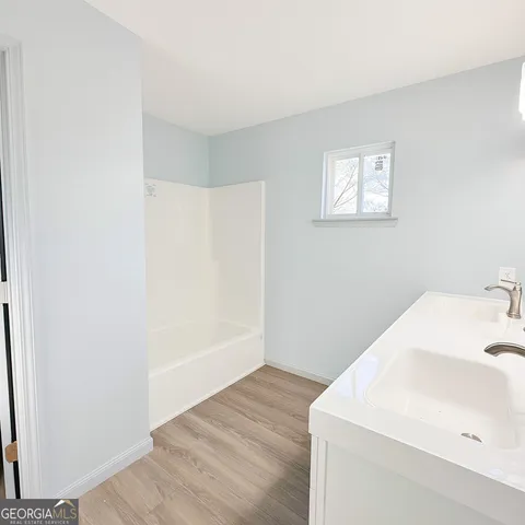 a bathroom with a sink and a window