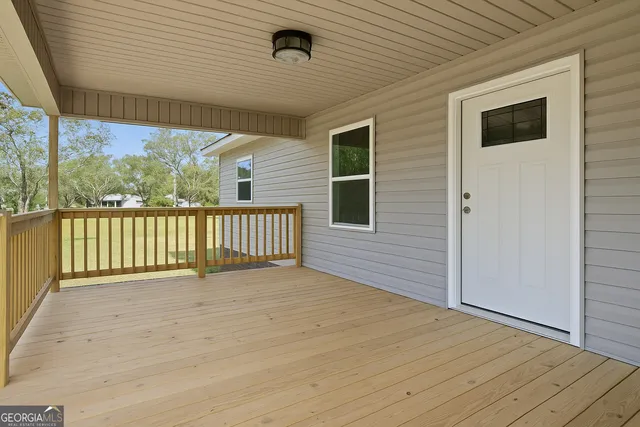 a view of a deck with wooden floor and fence