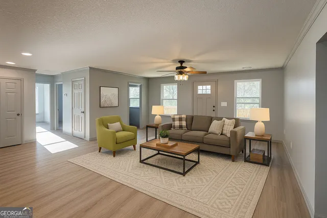 a living room with furniture and wooden floor