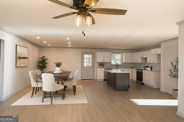 a view of a dining room with furniture window and wooden floor