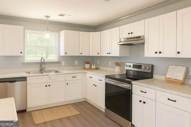 a kitchen with granite countertop white cabinets and white appliances