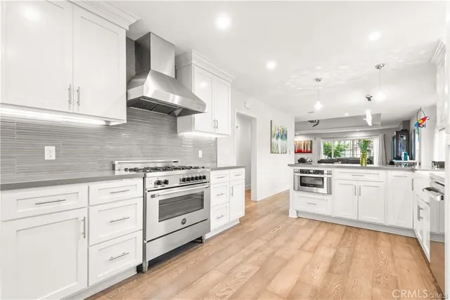 a kitchen with stainless steel appliances white cabinets and a stove