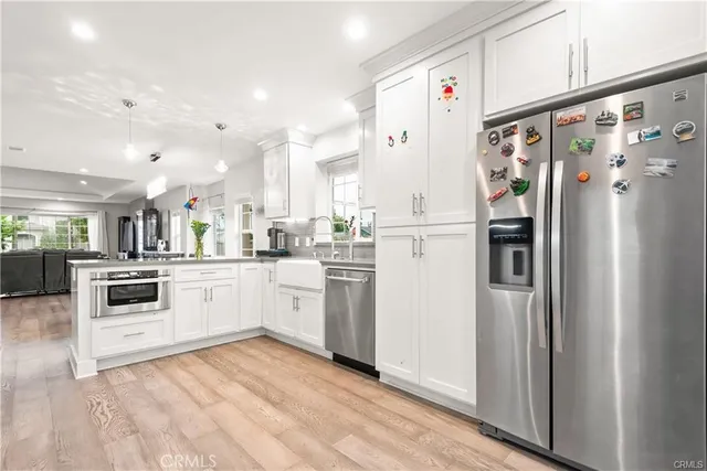 a kitchen with white cabinets and white appliances