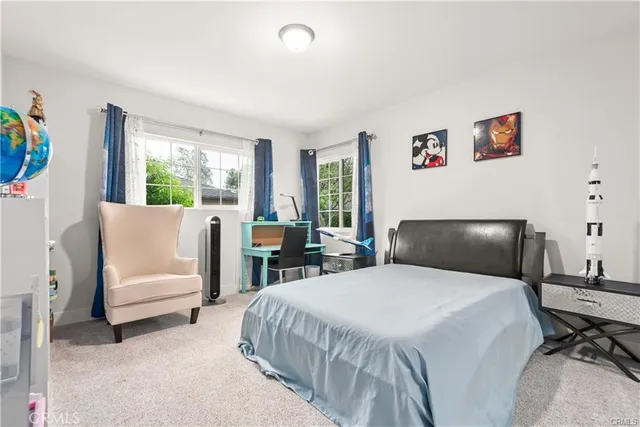 a bedroom with two beds and a couch