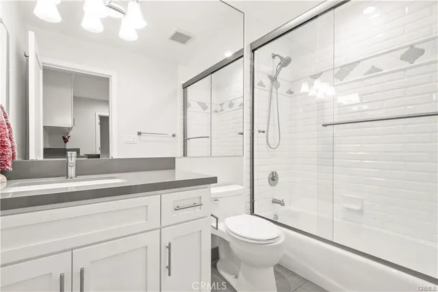 a living room with furniture and white cabinets