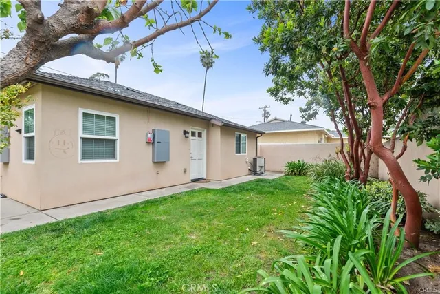a backyard of a house with plants and trees