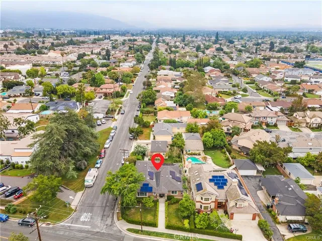 an aerial view of a house with a yard
