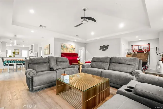 a living room with furniture and a chandelier
