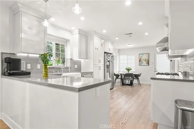 a kitchen with counter top space and windows