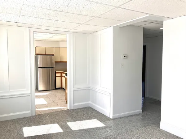 a view of a kitchen from a hallway