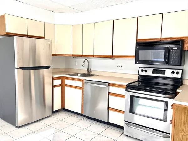 a kitchen with stainless steel appliances a stove sink and microwave