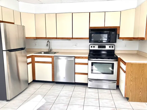 a kitchen with stainless steel appliances a refrigerator sink and cabinets