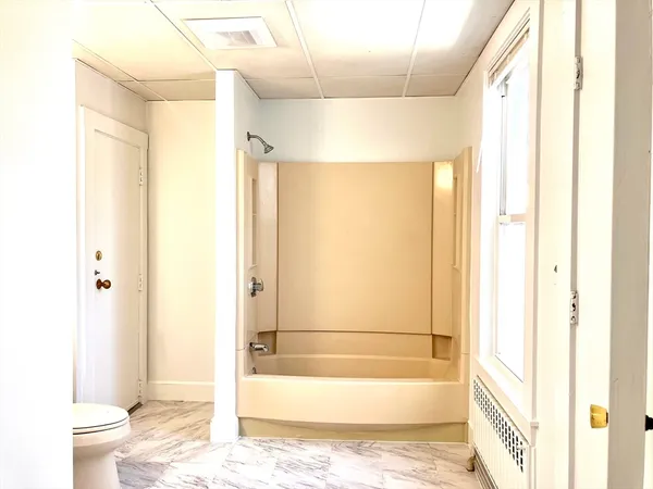 a bathroom with a toilet sink vanity and mirror