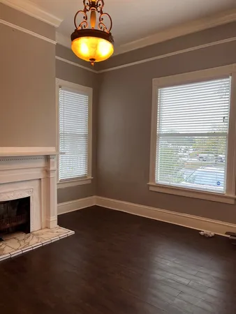 a view of a room with wooden floor and a window
