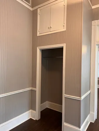 a view of walk in closet with wooden floor