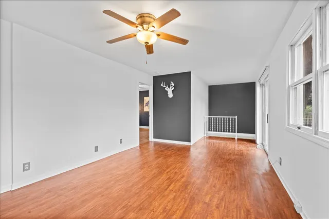 wooden floor in an empty room with a window