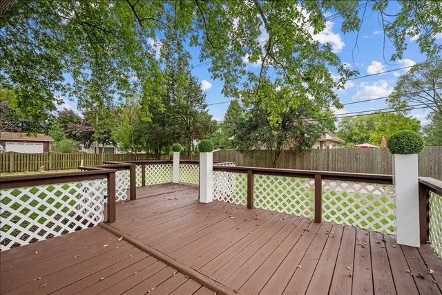 a front view of a house with yard and green space