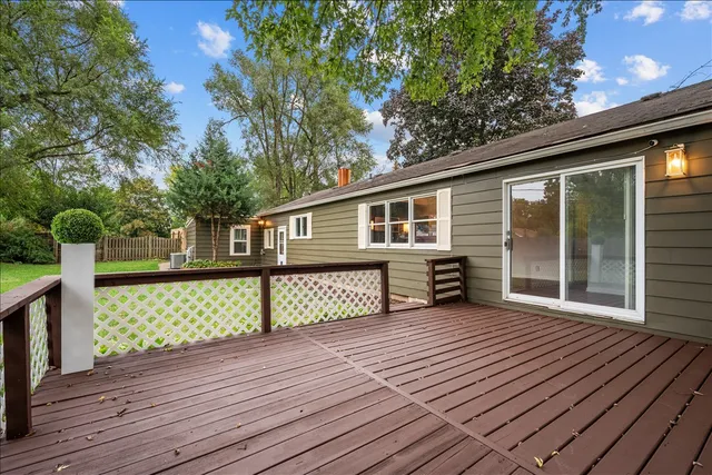 a view of a house with a big yard and basketball court