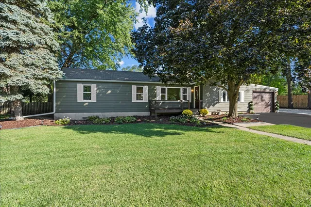 a front view of a house with a yard and a garage