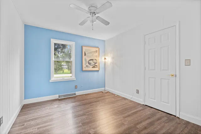 wooden floor in an empty room with a window