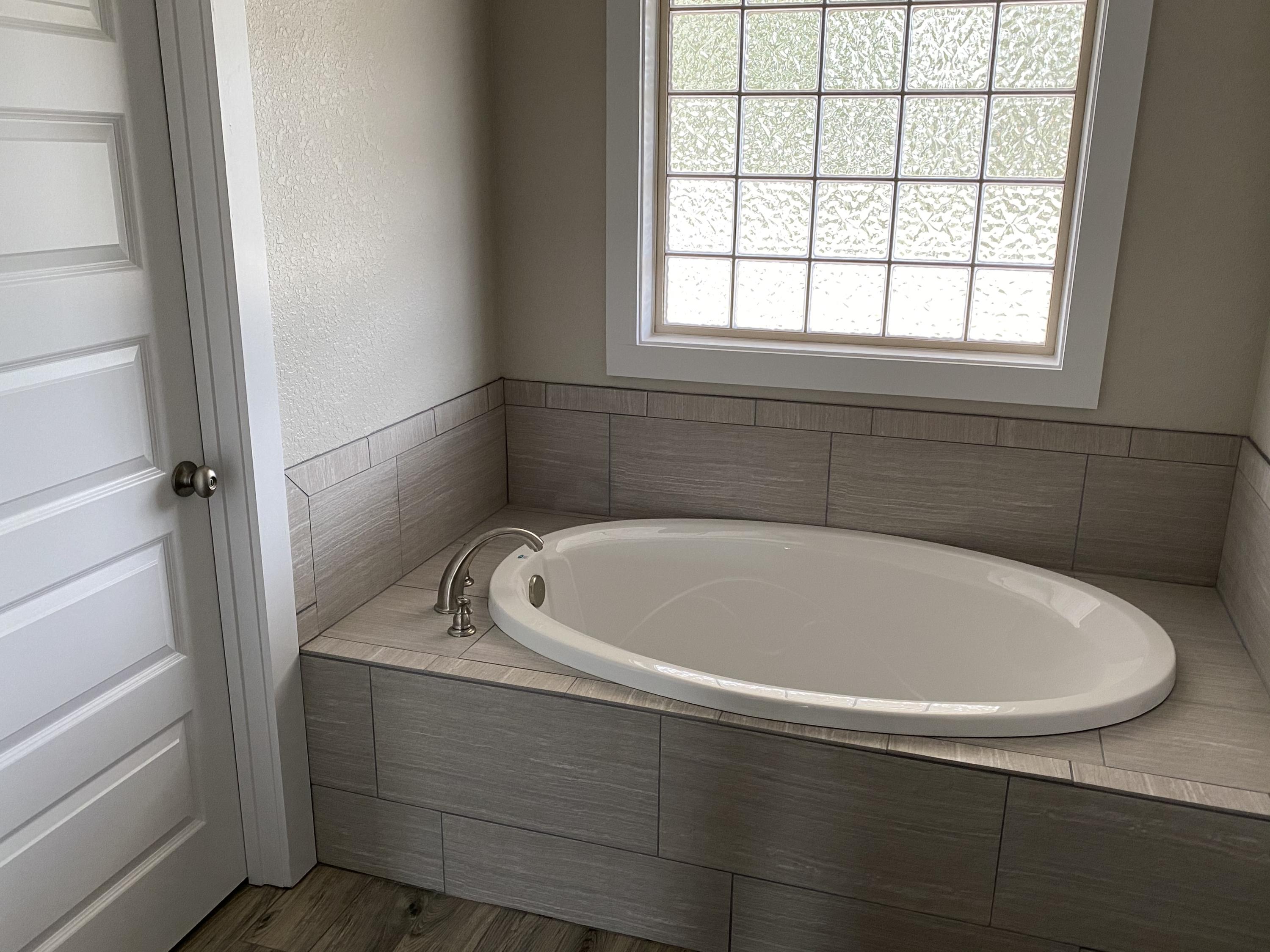 3958 Painter Branch Road Crestview, FL 32539 - Photo 12 of 15 a bathroom with a bathtub