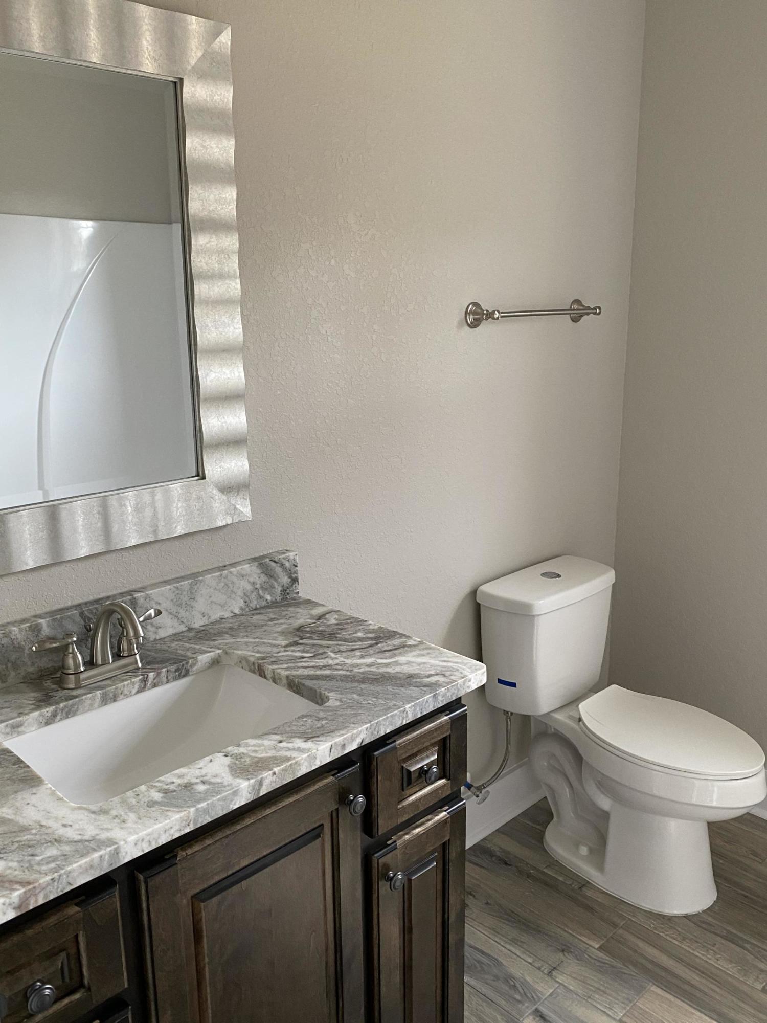 3958 Painter Branch Road Crestview, FL 32539 - Photo 15 of 15 a bathroom with a granite countertop sink and a toilet