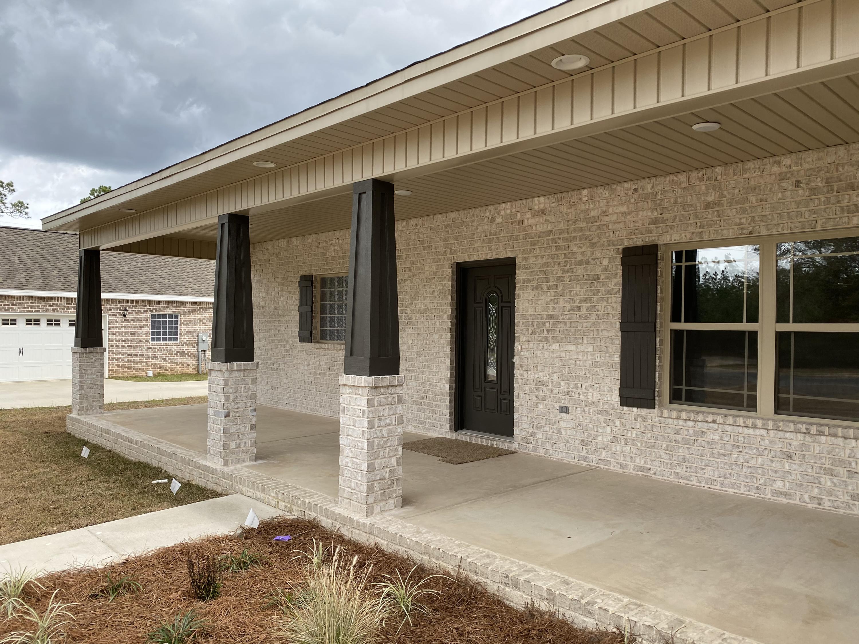 3958 Painter Branch Road Crestview, FL 32539 - Photo 3 of 15 a front view of a house with glass windows and tub