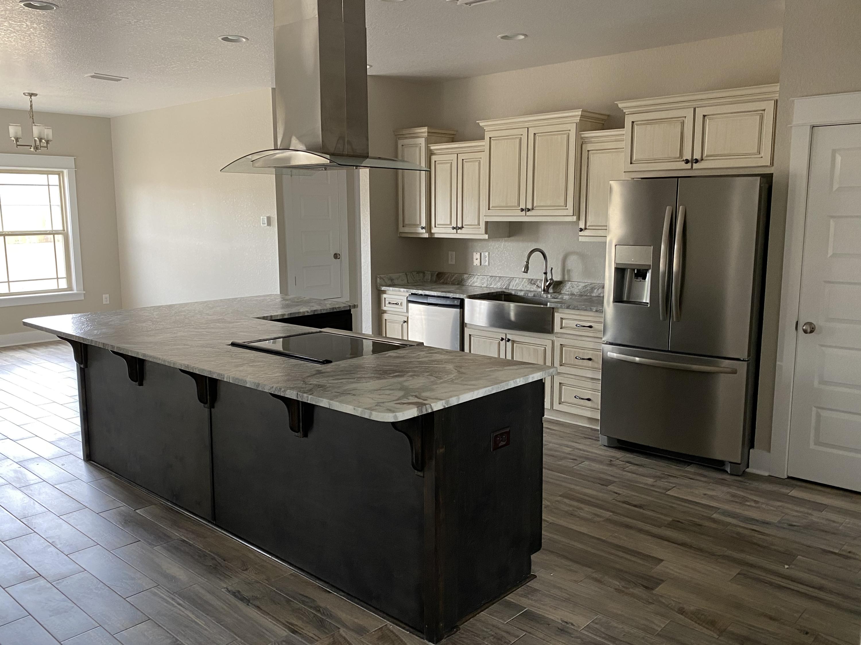 3958 Painter Branch Road Crestview, FL 32539 - Photo 4 of 15 a kitchen with kitchen island granite countertop a sink appliances and cabinets