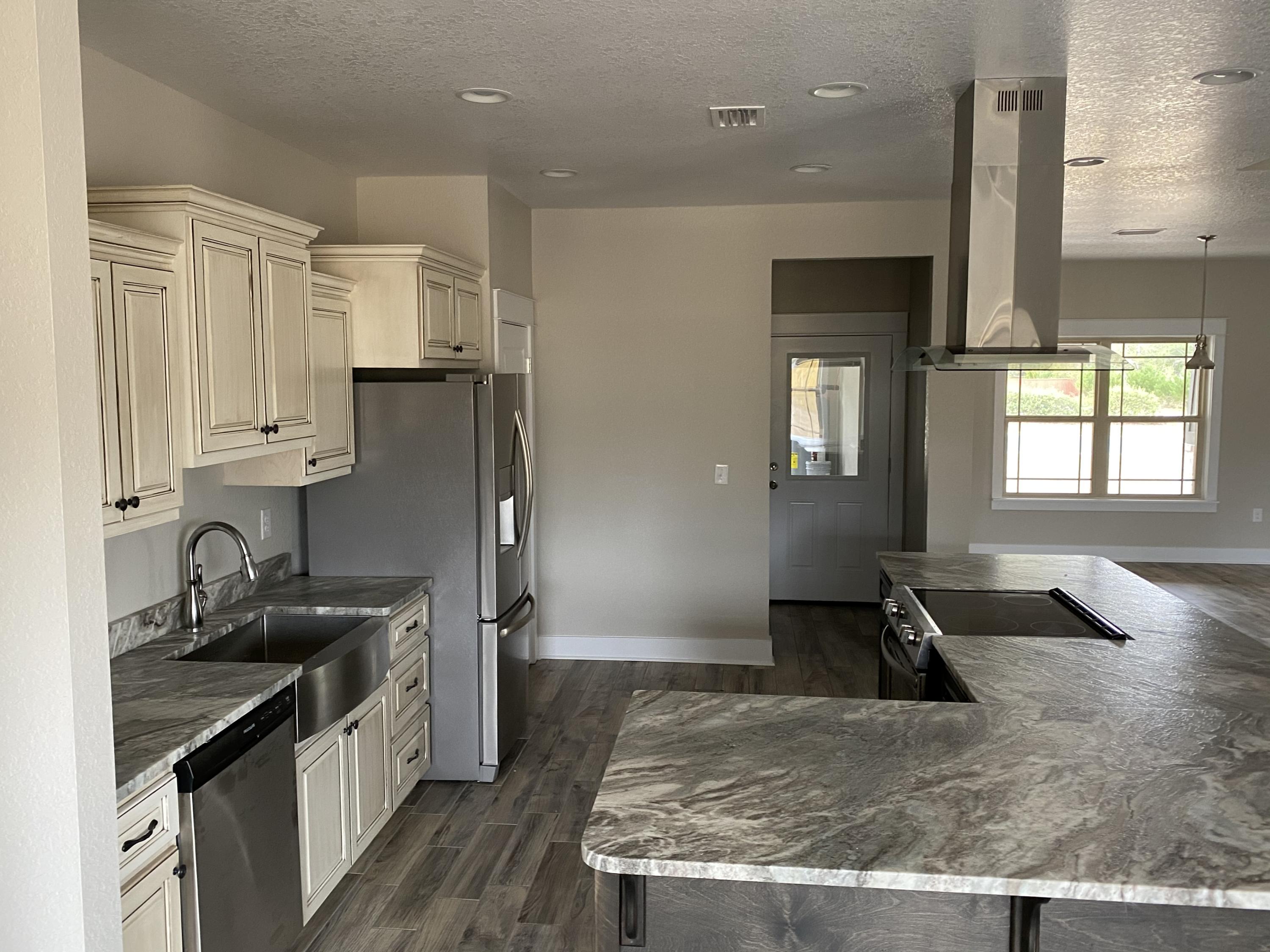 3958 Painter Branch Road Crestview, FL 32539 - Photo 5 of 15 a kitchen with stainless steel appliances granite countertop a sink stove and refrigerator