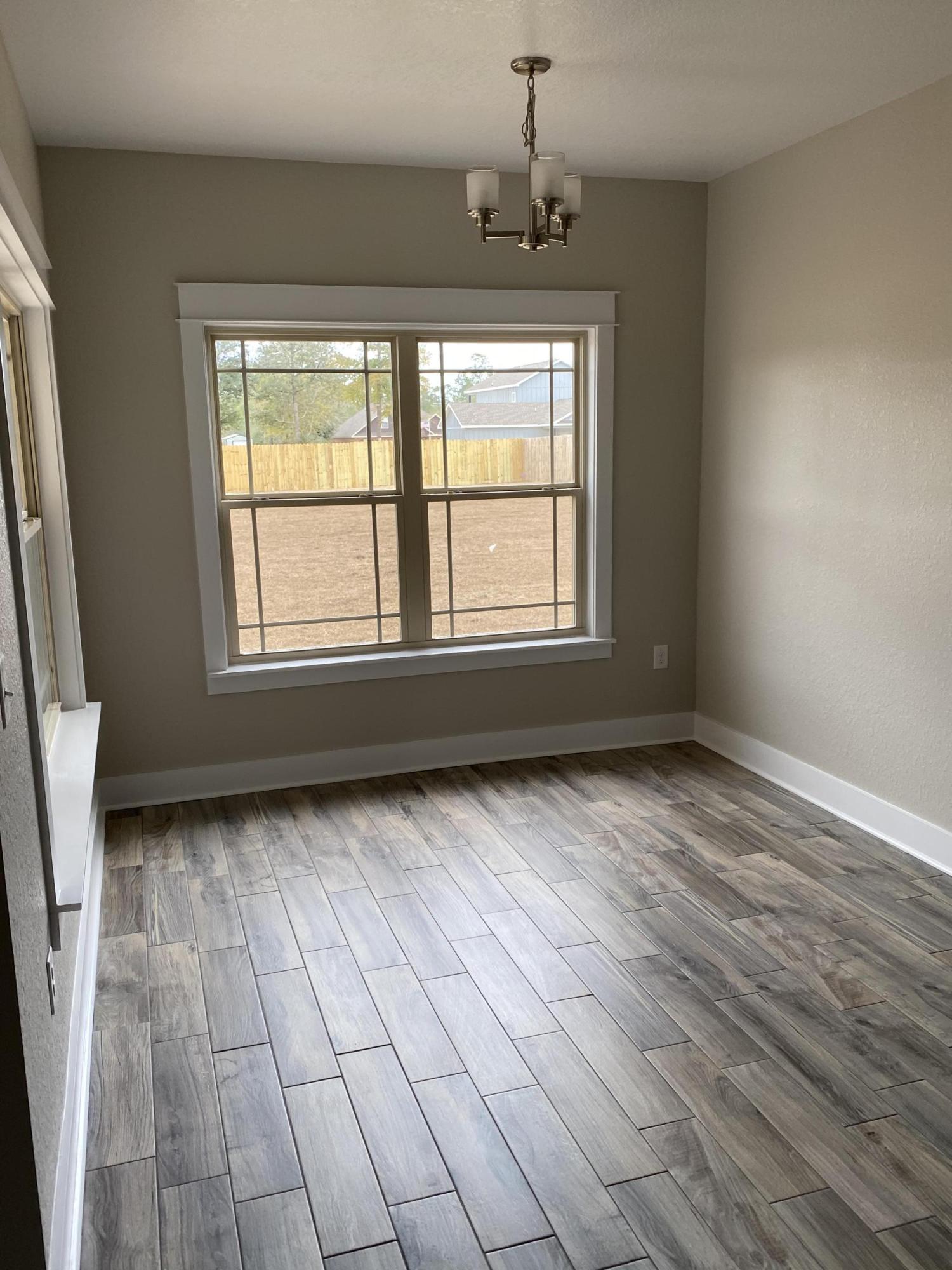 3958 Painter Branch Road Crestview, FL 32539 - Photo 8 of 15 an empty room with windows