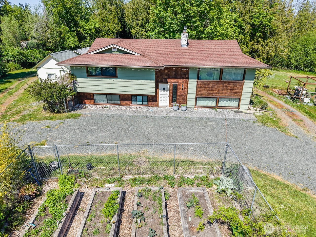 63 East Arnette Road Port Angeles, WA 98362 - Photo 9 of 40 a front view of a house with a yard and garage