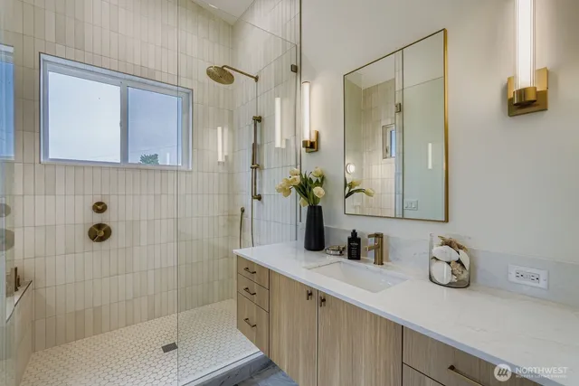 a bathroom with a shower sink and mirror