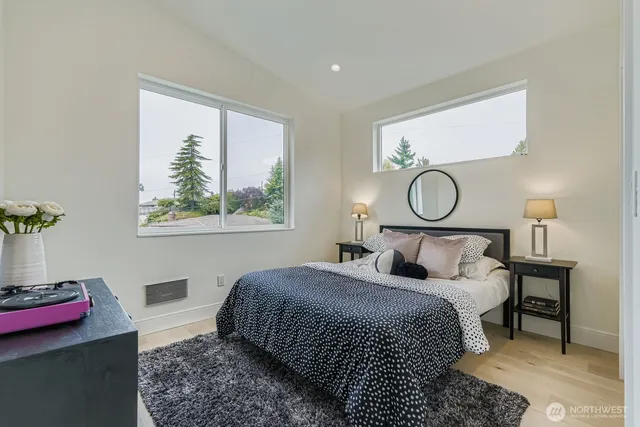 a bedroom with a bed and dresser with mirror