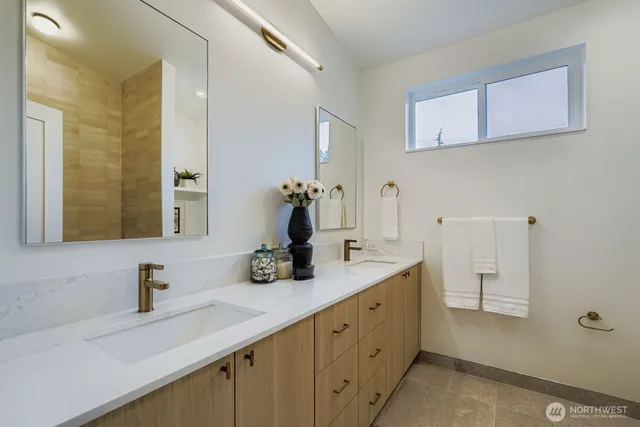 a bathroom with a double vanity sink mirror and