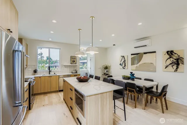 a kitchen with a table chairs stove and refrigerator