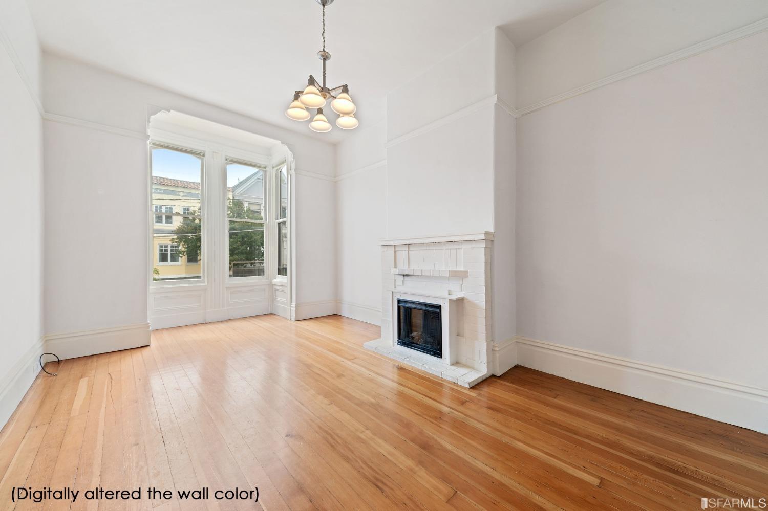 3754 Cesar Chavez San Francisco, CA 94110 - Photo 3 of 16 a view of empty room with wooden floor and fireplace