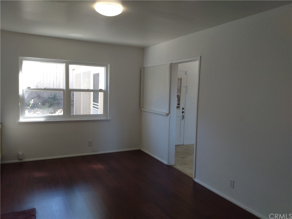 357 Parkman Street Altadena, CA 91001 - Photo 40 of 73 a view of an empty room with wooden floor and a window