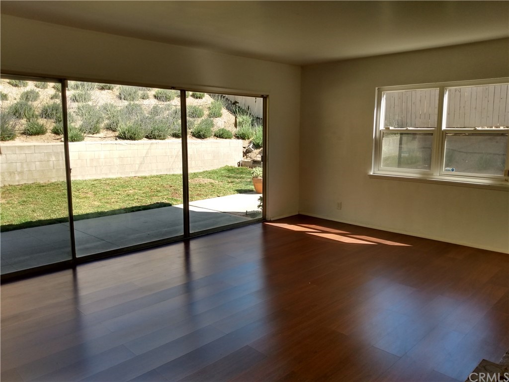 357 Parkman Street Altadena, CA 91001 - Photo 47 of 73 a view of an empty room with wooden floor and windows