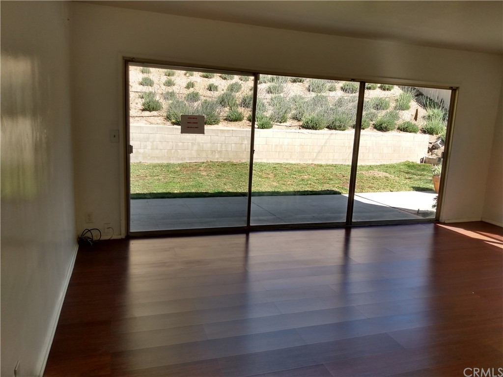 357 Parkman Street Altadena, CA 91001 - Photo 48 of 73 a view of an empty room with wooden floor and a floor to ceiling window