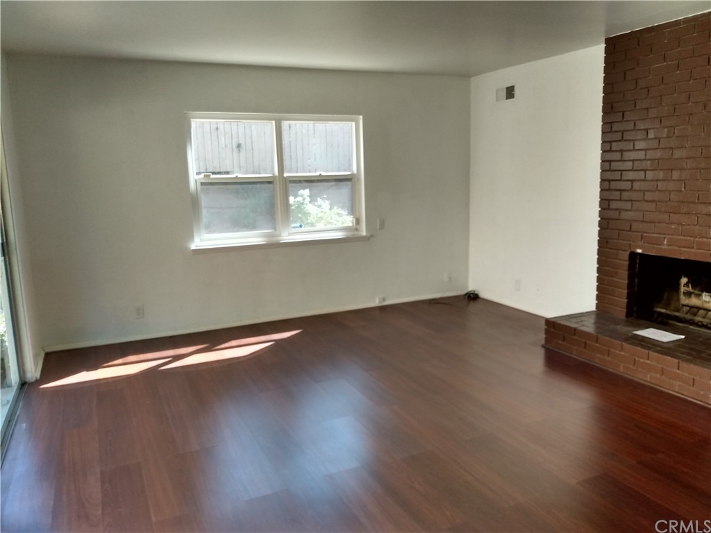 357 Parkman Street Altadena, CA 91001 - Photo 51 of 73 an empty room with wooden floor and windows