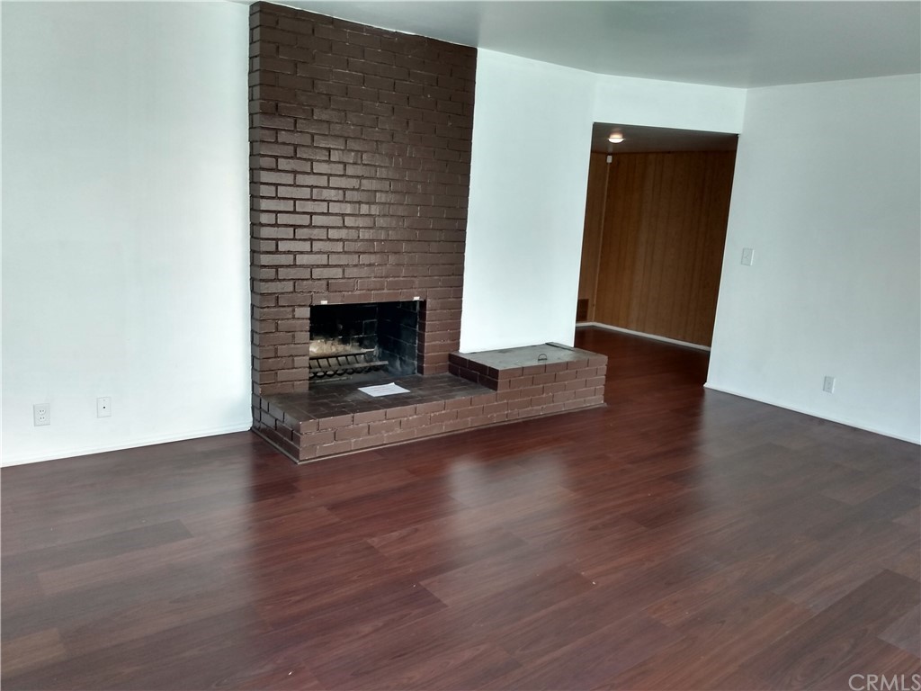 357 Parkman Street Altadena, CA 91001 - Photo 52 of 73 an empty room with wooden floor and fireplace