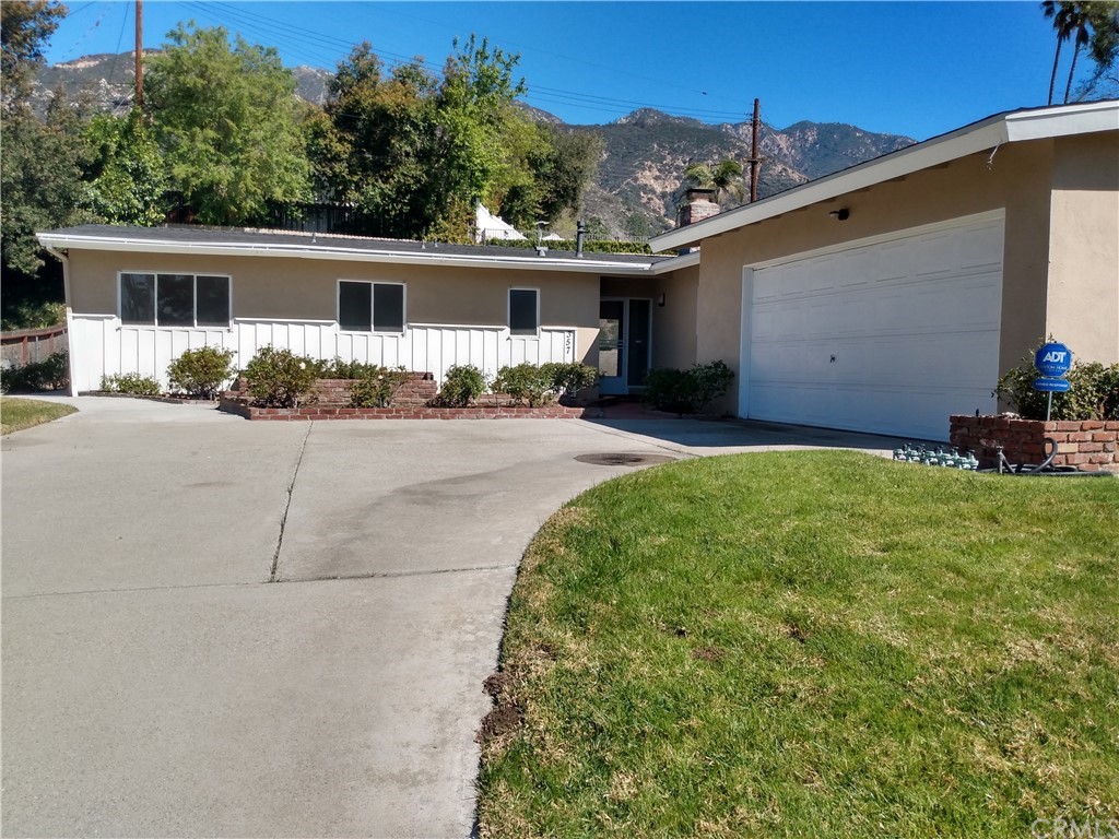 357 Parkman Street Altadena, CA 91001 - Photo 6 of 73 a front view of house with yard and trees in the background