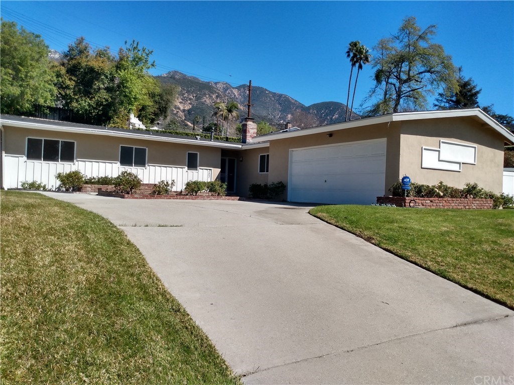 357 Parkman Street Altadena, CA 91001 - Photo 7 of 73 a front view of a house with a yard and garage