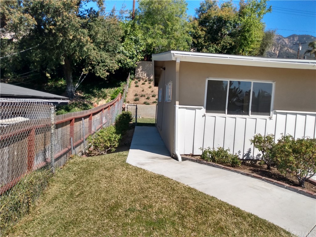 357 Parkman Street Altadena, CA 91001 - Photo 10 of 73 a view of a house with a small yard and wooden fence