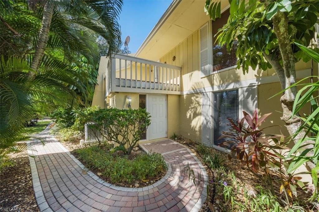 a view of a house with a flower garden