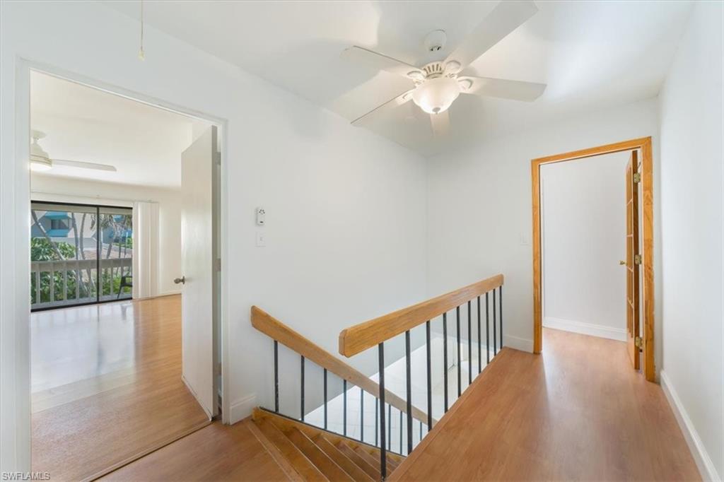 925 Palm View Drive, Unit E118 Naples, FL 34110 - Photo 16 of 26 a view of a hallway with wooden floor and windows