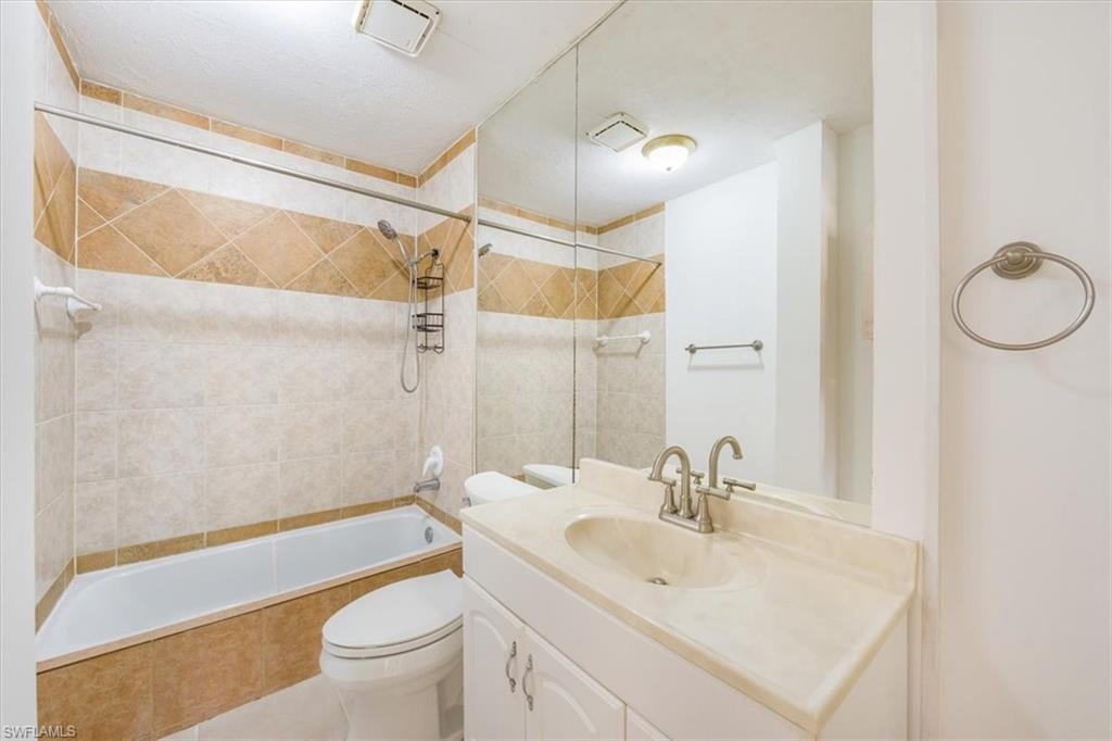 925 Palm View Drive, Unit E118 Naples, FL 34110 - Photo 20 of 26 a bathroom with a sink a toilet and shower