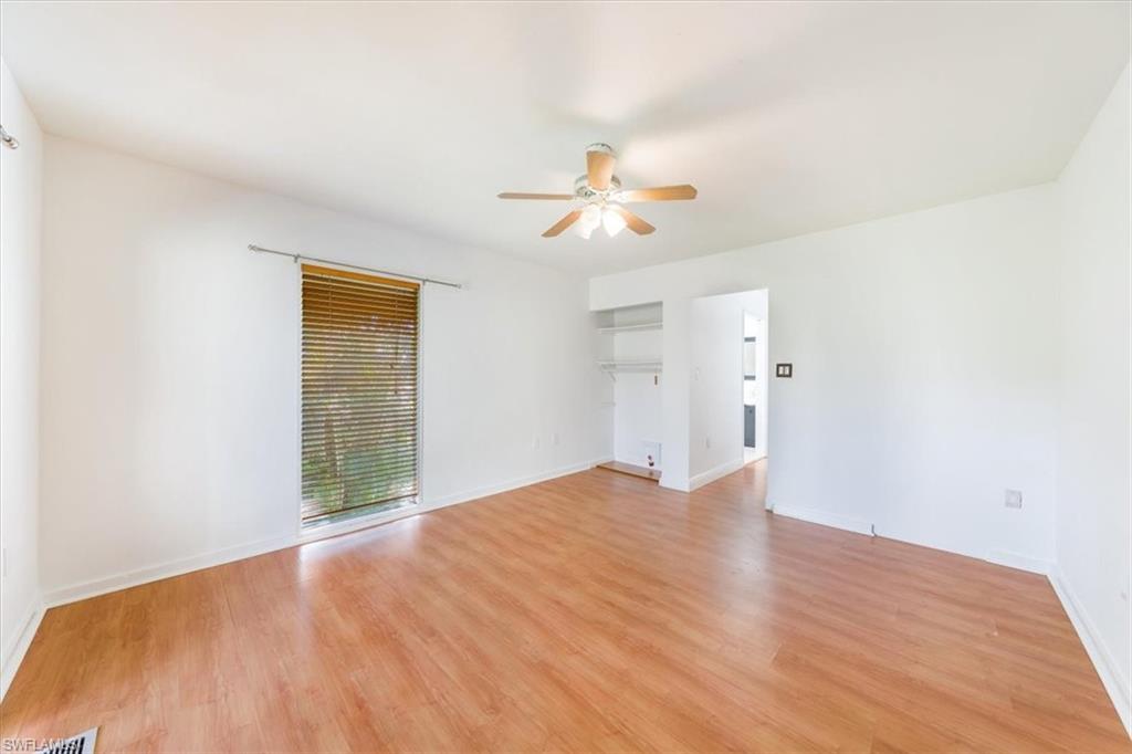 925 Palm View Drive, Unit E118 Naples, FL 34110 - Photo 23 of 26 a view of an empty room with a window and a kitchen